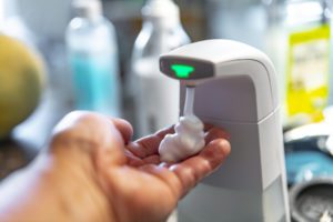Automatic Soap Dispenser a hand holding the soap coming out of the soap dispenser